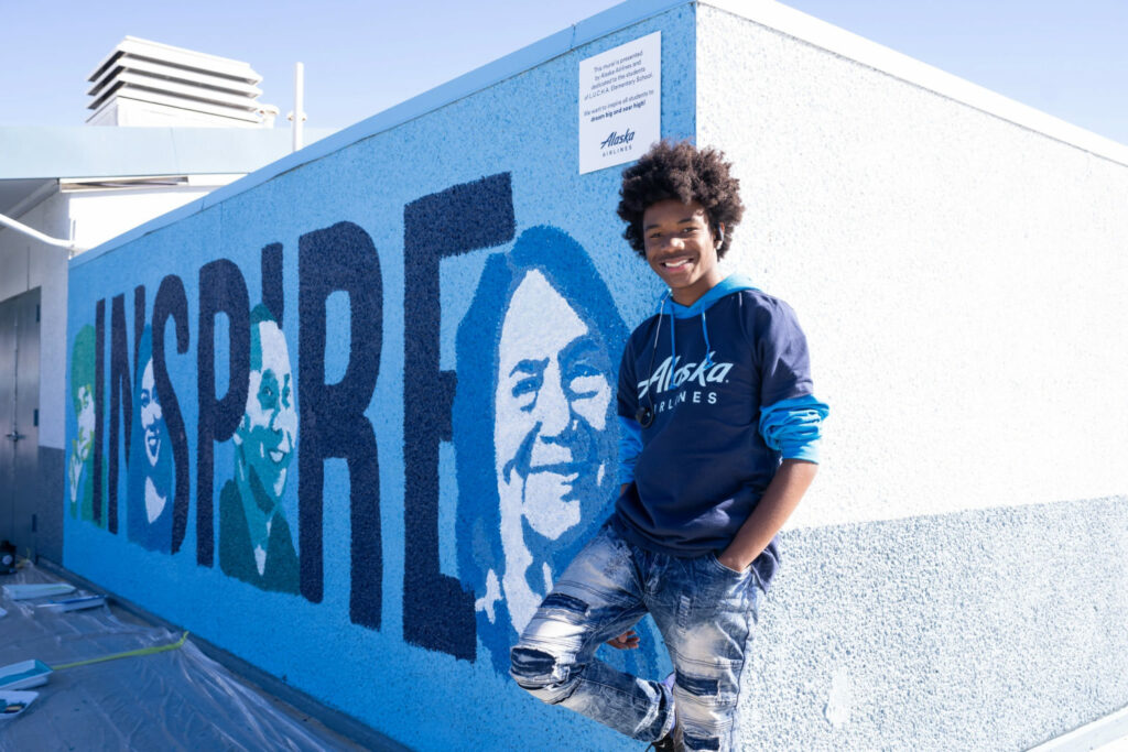 Tyler Gordon in front of the mural