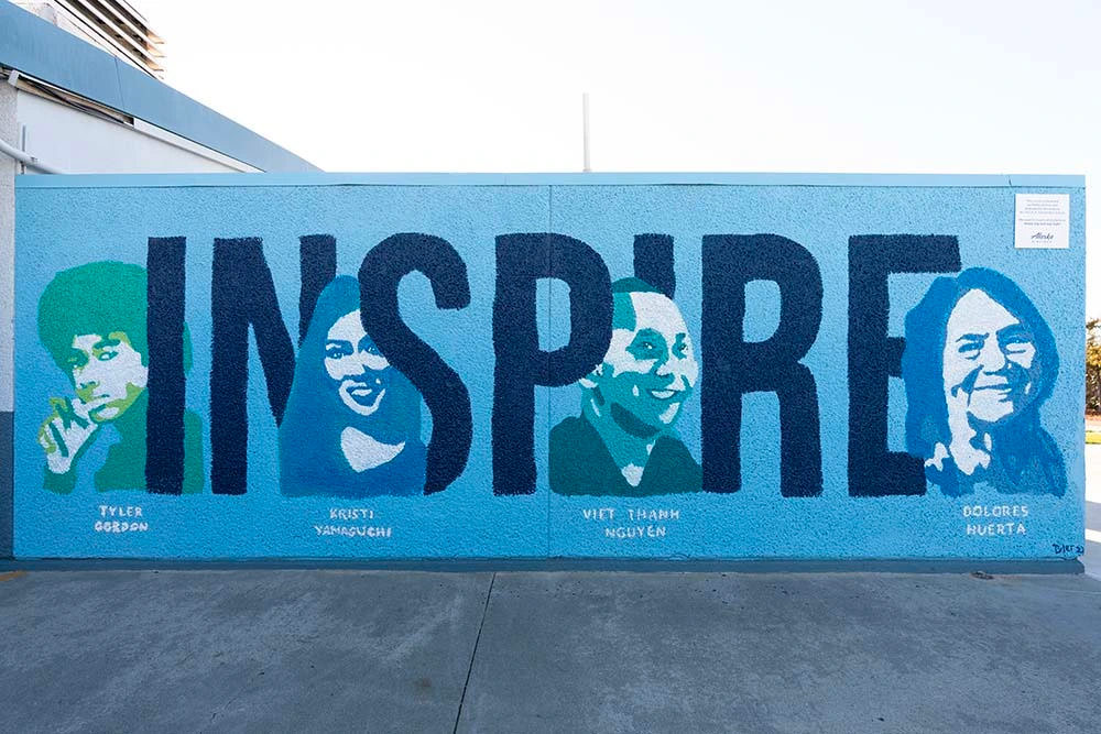 Murals of influential Bay Area figures at L.U.C.H.A. Elementary School, including Kristi Yamaguchi, Dolores Huerta, Viet Thanh Nguyen, a self-portrait of the painter Gordon Tyler